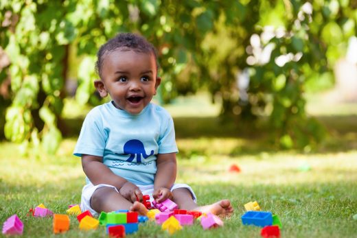 Child with legos smiling