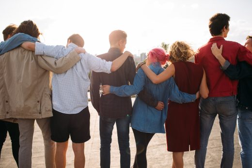 Group of friends with arms around each other