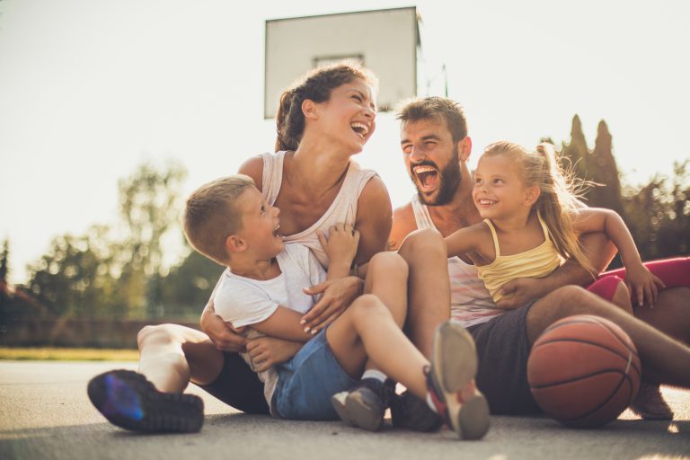 Family laughing on basketball court
