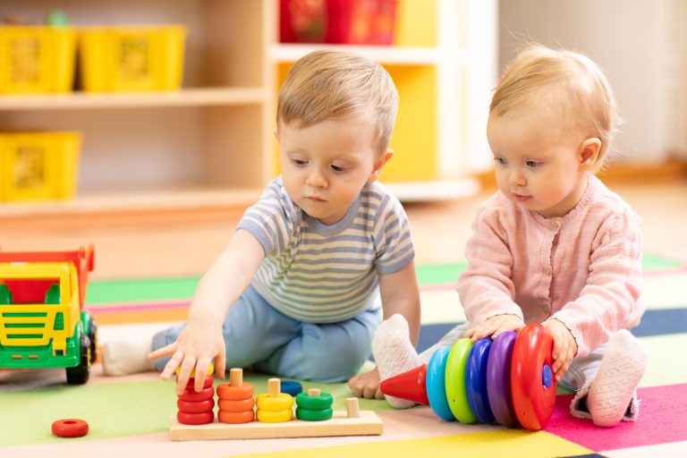 Two children playing ring game in early education classroom