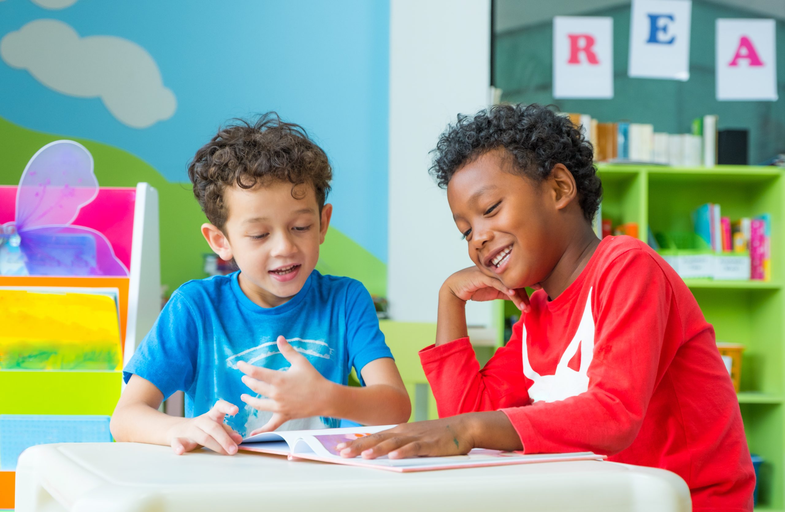 Two young boys sharing a book