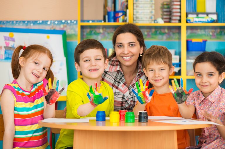 Preschool teacher painting with kids