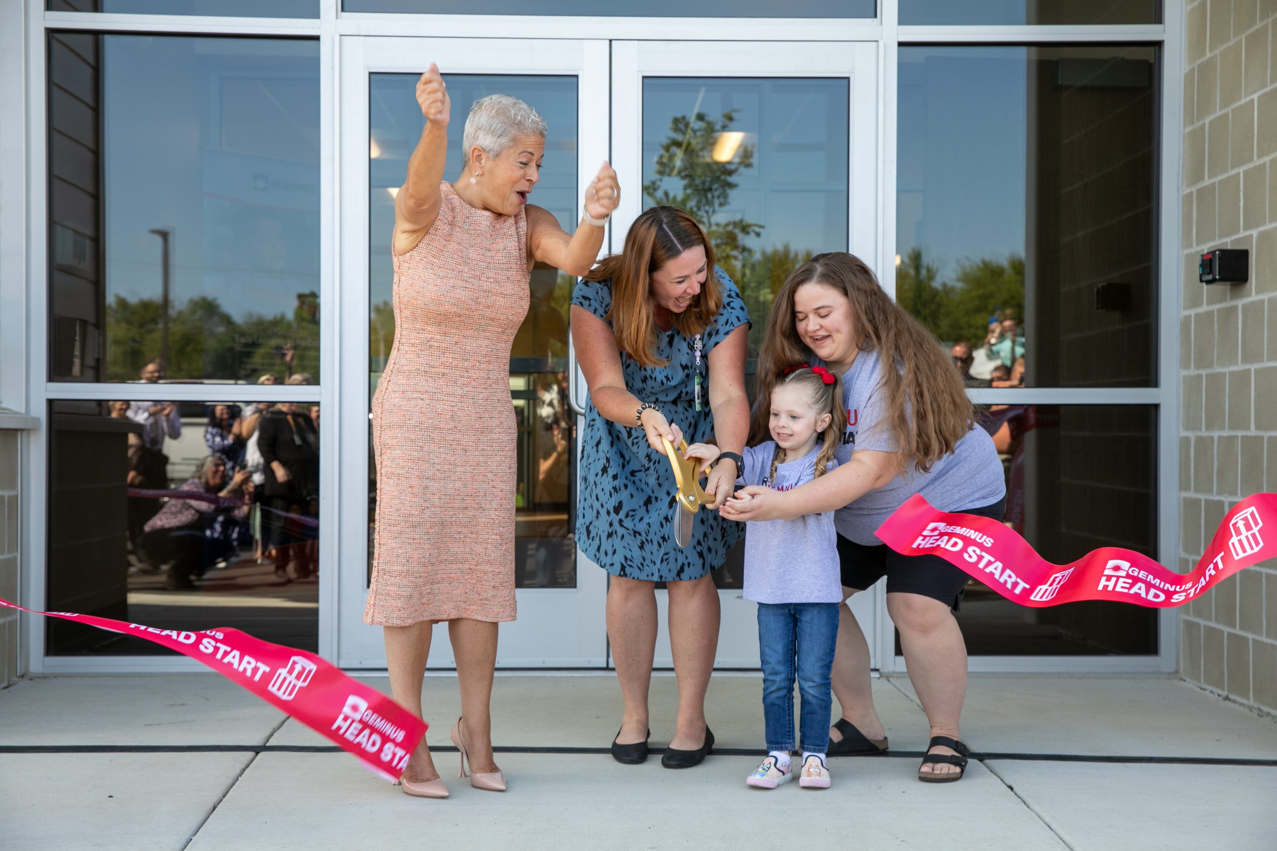 Dr. Carradine cheers while ribbon is cut